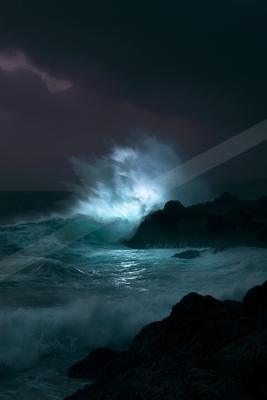 A blue hour water scene of ocean, storm, waterfall.