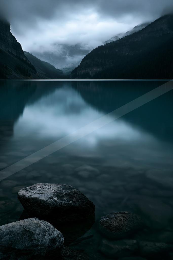A blue hour long exposure water scene of lake, reflection.