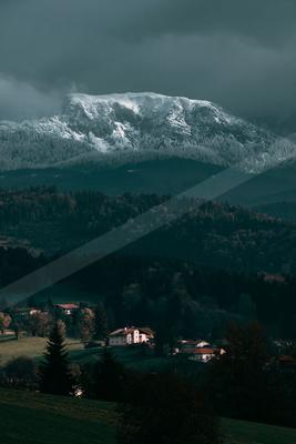 A black-toned moody photograph of alp, valley, volcano.