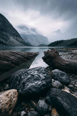 A gray-toned bright photograph of valley, lakeside, alp.