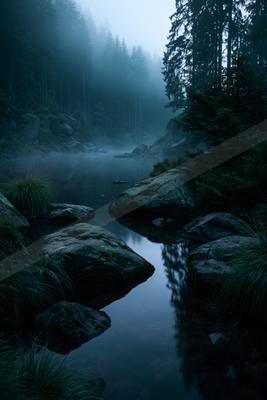 A night long exposure water scene of river, lake, fog.
