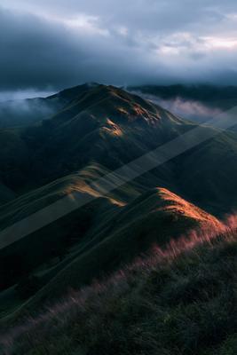 A moody landscape of mountains.