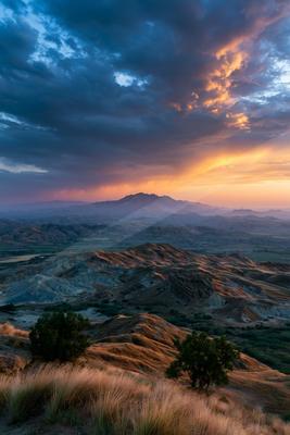 A moody landscape of desert, mountains, valley.