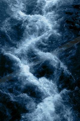 A moody water scene of waterfall, river, abstract texture.