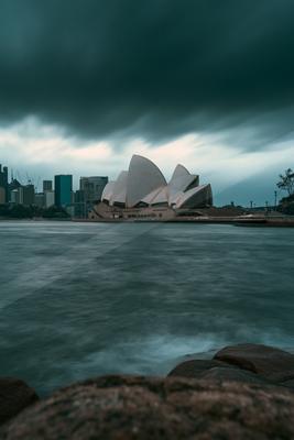 A night long exposure sky scene of storm, city skyline, clouds.