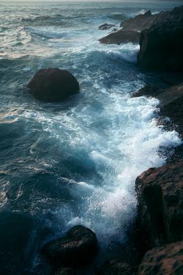 A dramatic long exposure water scene of ocean, rocks.