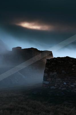 A night long exposure sky scene of storm, mountains, clouds.