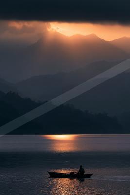 A brown-toned moody photograph of lakeside, valley, volcano.