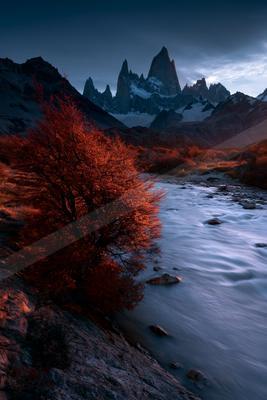 A serene landscape of mountains, river, valley.