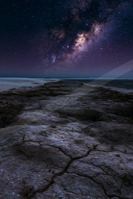 A night sky scene of starry sky, rocks.
