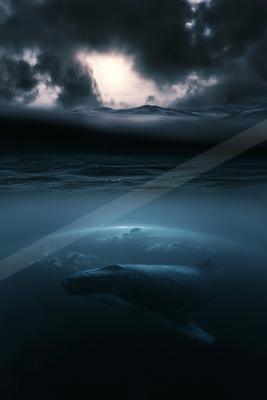 A moody sky scene of clouds, storm, ocean.