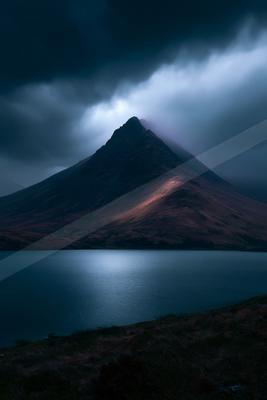 A dramatic long exposure landscape of mountains, lake.