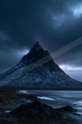 A moody landscape of mountains.