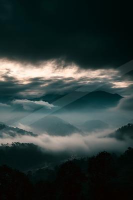 A brown-toned moody photograph of alp, volcano, valley.