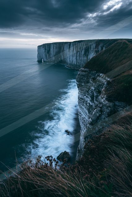 A blue hour long exposure landscape of a cliff, rocks.