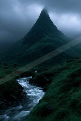 A moody landscape of mountains, valley.