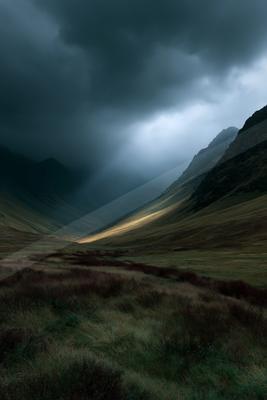 Dramatic crepuscular rays pierce through dark storm clouds into a vast mountain valley covered in green and purple heather under moody skies.