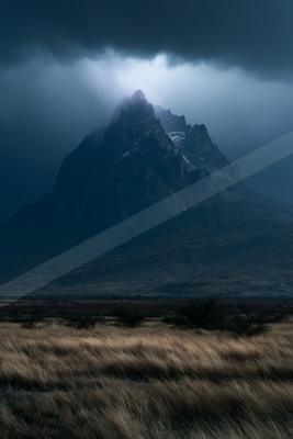 A moody landscape of mountains.