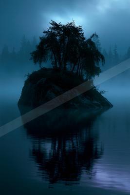 A blue hour water scene of lake, fog.