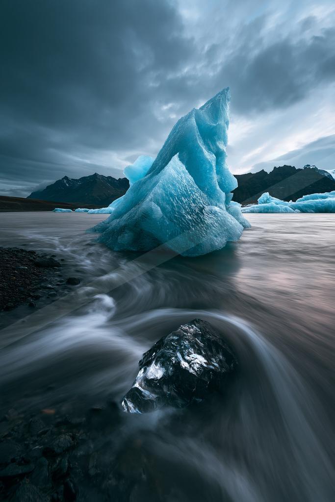 A blue hour water scene of waterfall, ocean, river.