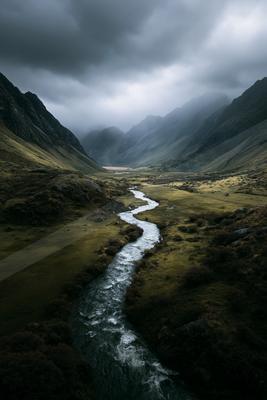 A moody water scene of river, valley.