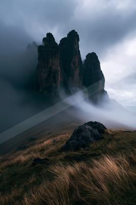 A dramatic high contrast landscape of a plateau, fog.