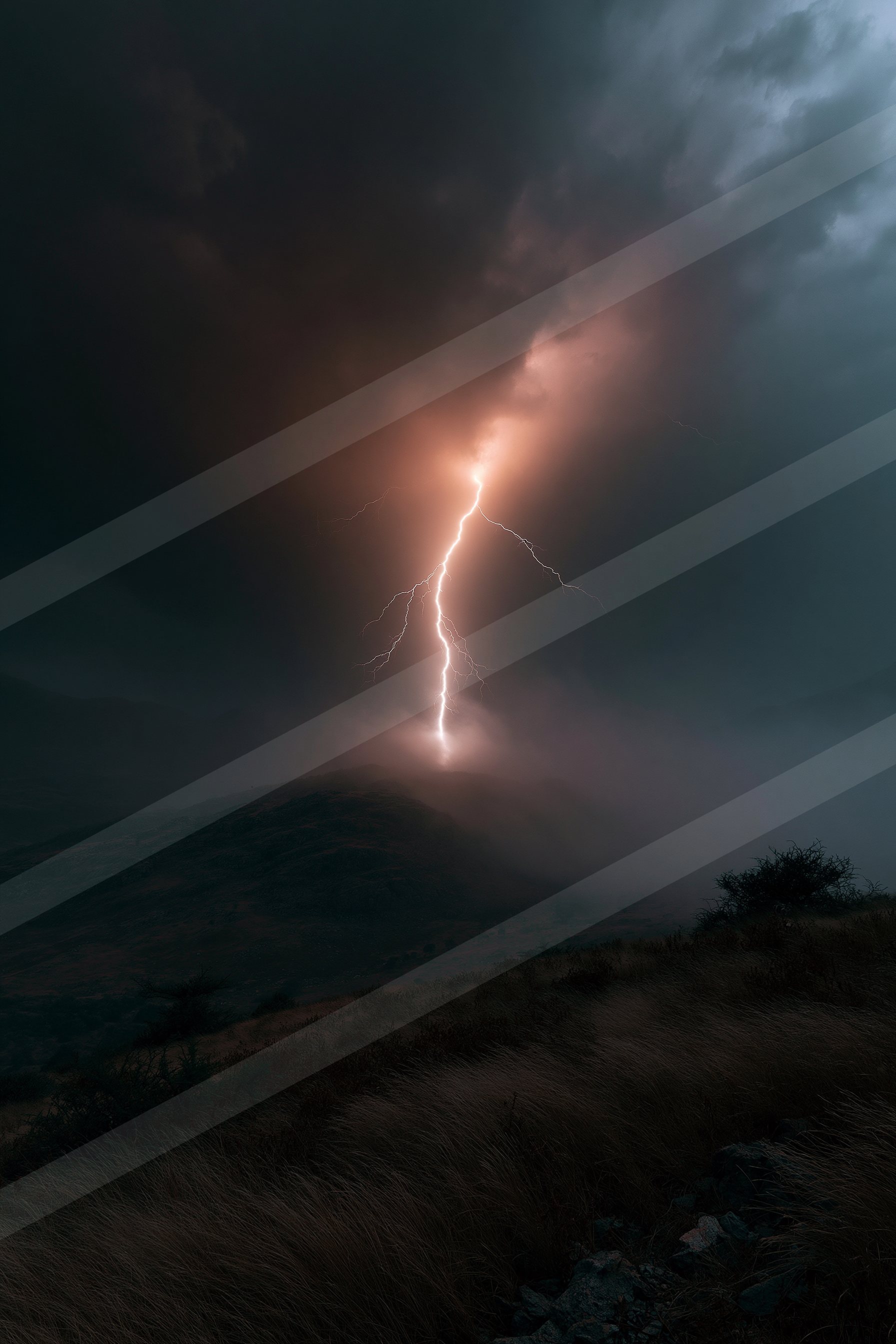 A powerful lightning bolt illuminates the dark sky above a mountainous landscape.