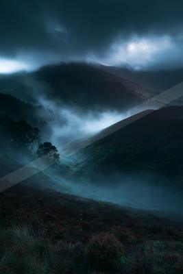 A night long exposure sky scene of storm, mountains, valley.