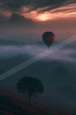 A serene sky scene of sunrise, valley, fog.