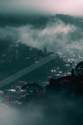 A brown-toned moody photograph of alp, volcano, promontory.