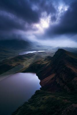 A blue hour long exposure water scene of lake, mountains, valley.