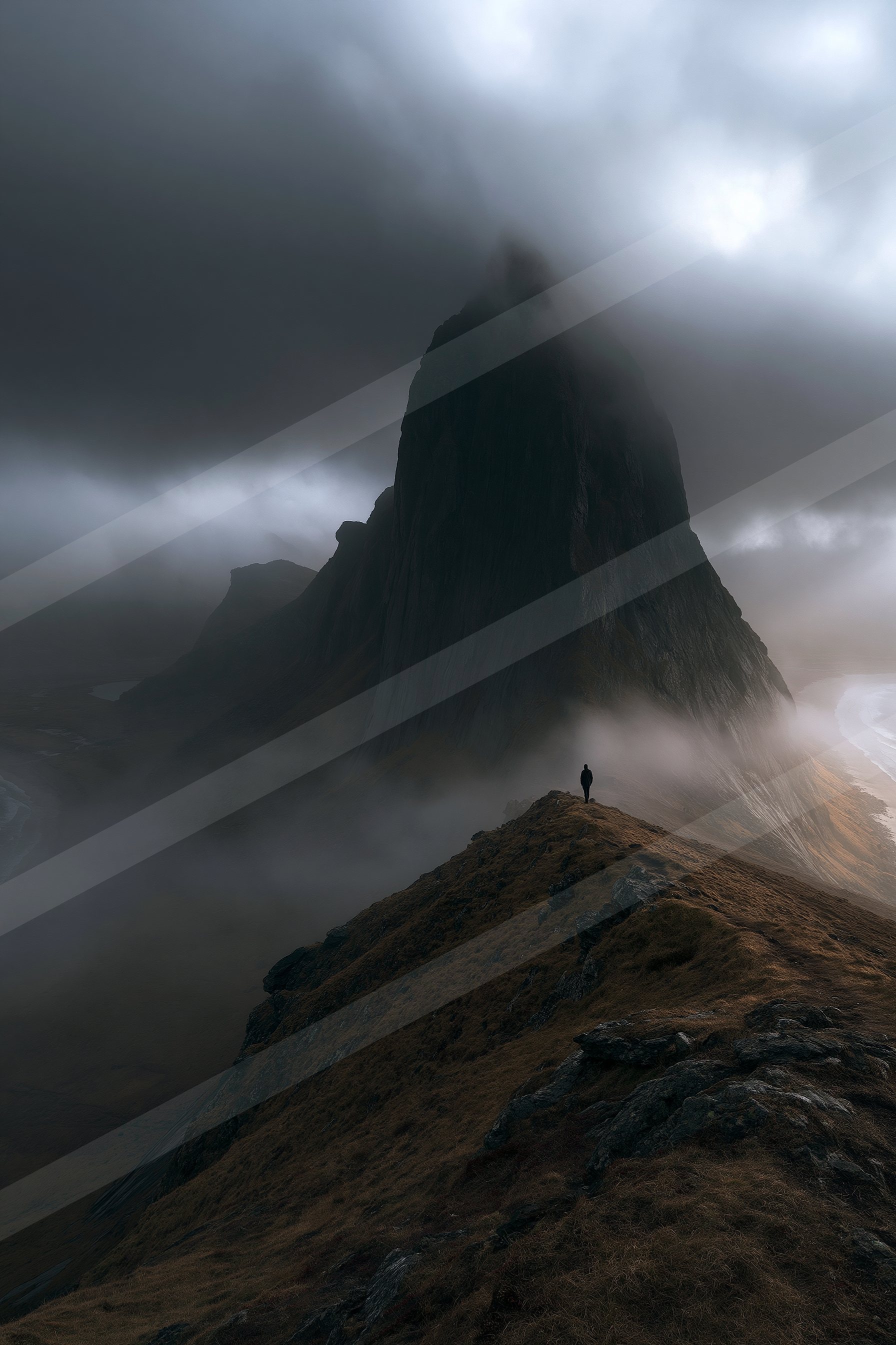 A black-and-white mysterious landscape of a mountains, fog.