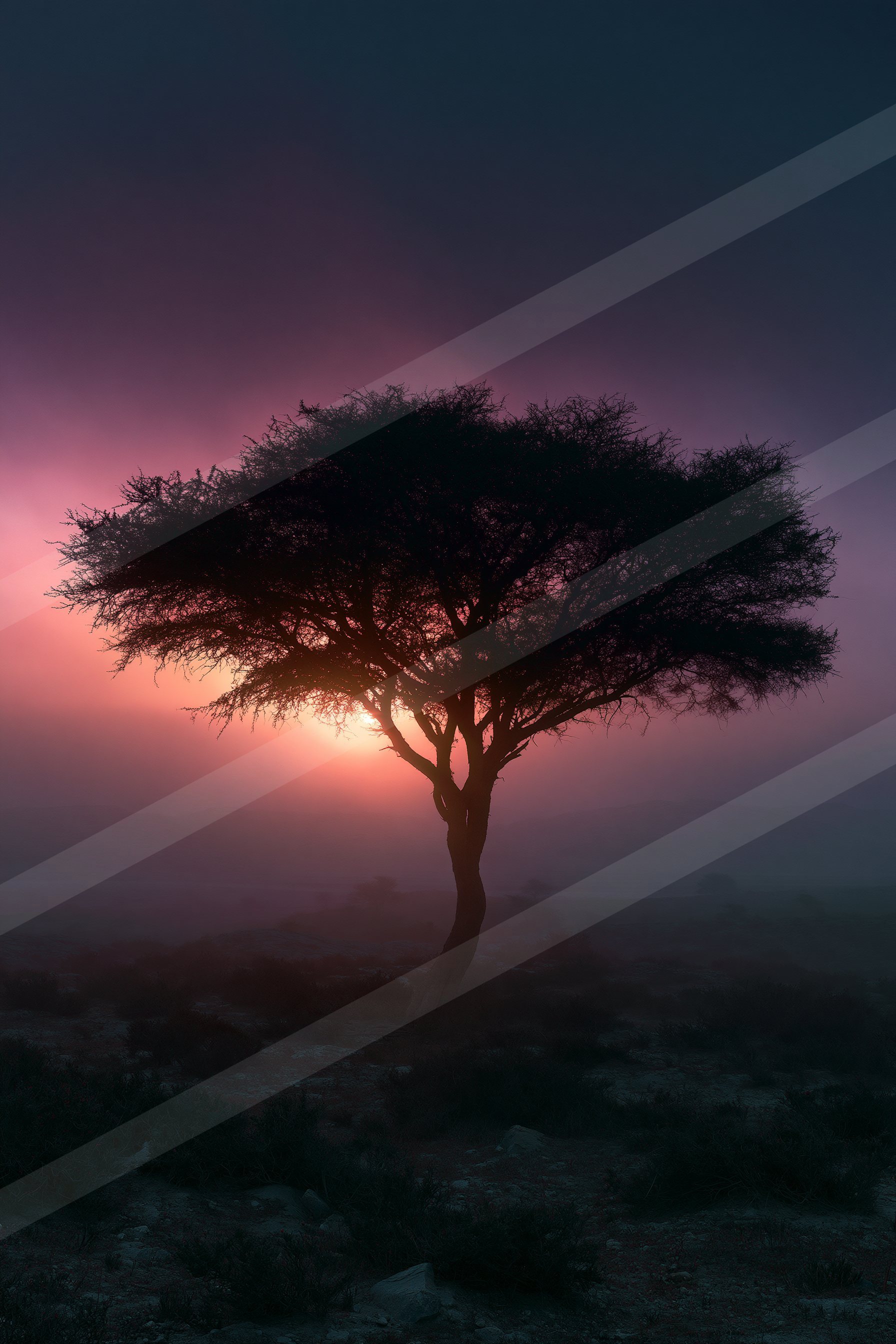 A lone tree stands silhouetted against a vibrant twilight sky with hues of pink and purple.