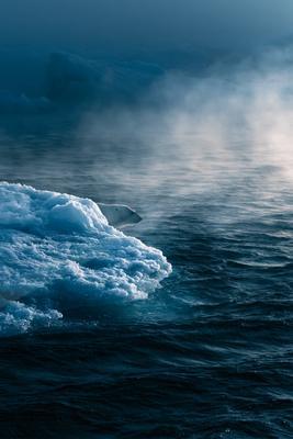A dramatic water scene of ocean, fog.