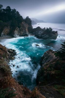 A blue hour long exposure water scene of ocean, storm, fog.