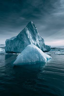 A dramatic water scene of ocean, mountains.