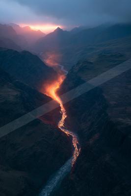 A black-toned moody photograph of valley, volcano, cliff.