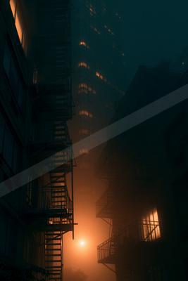 A moody street scene of city skyline, city street, building.