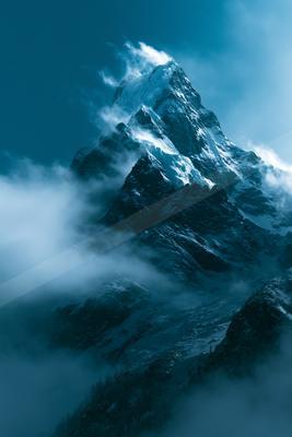 An ethereal high-key landscape of a mountains, fog.