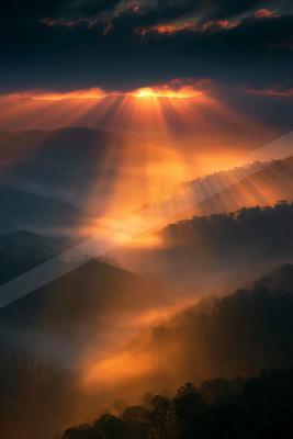 A golden hour landscape of mountains, sunrise, sunset.