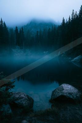 A blue hour long exposure water scene of lake, fog.