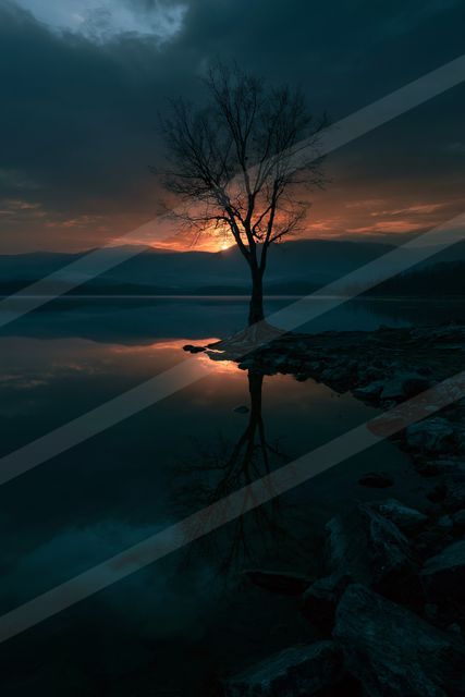 A dramatic high contrast sky scene of a sunset, reflection.