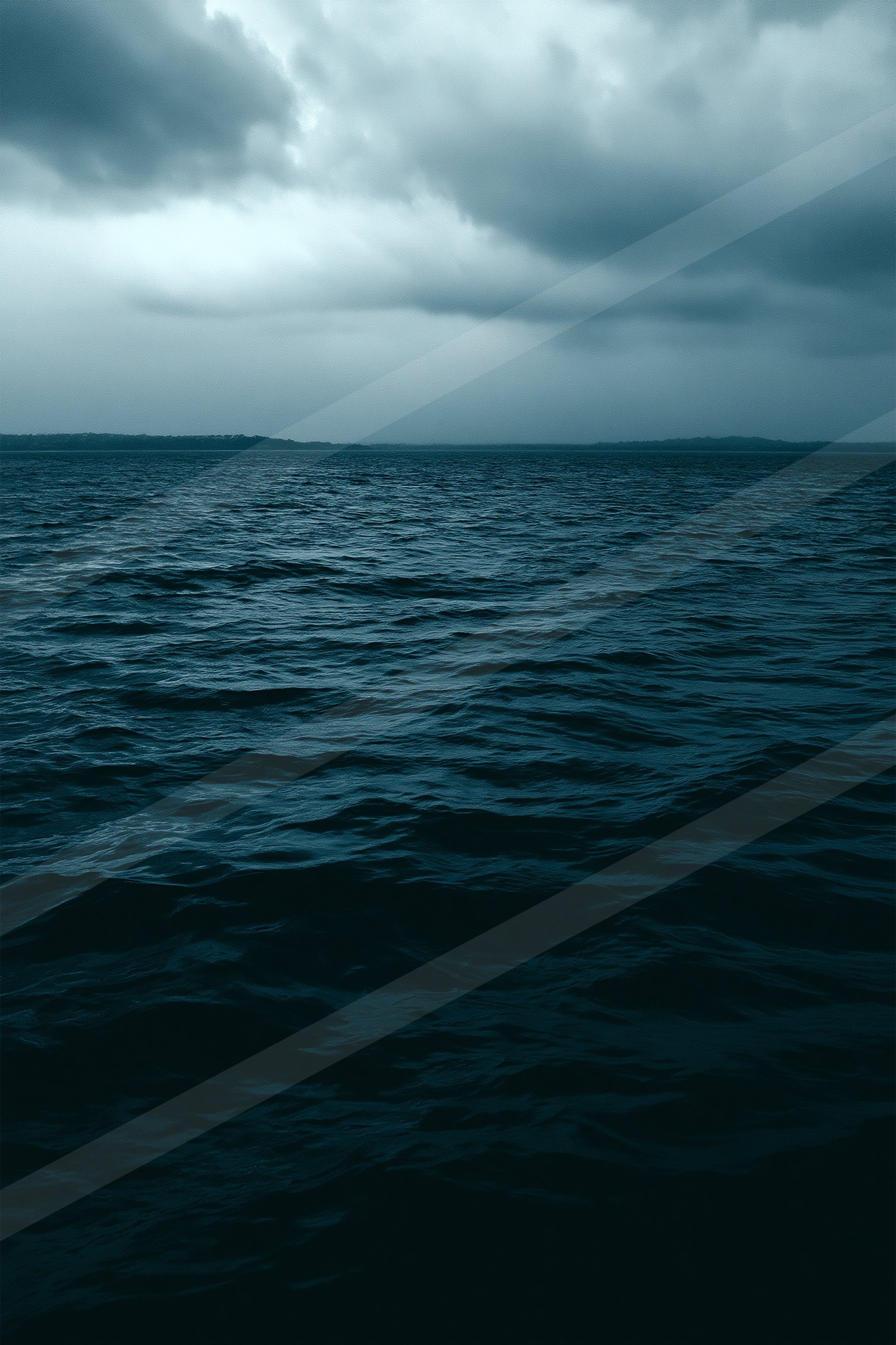 A moody high contrast water scene of an ocean, ripples.