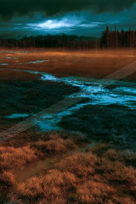 A blue hour landscape of field, river, lake.