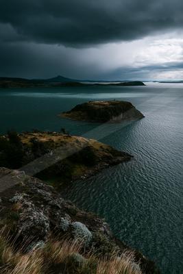 A moody sky scene of storm, lake, clouds.