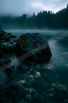 A blue hour long exposure water scene of river, lake, ocean.