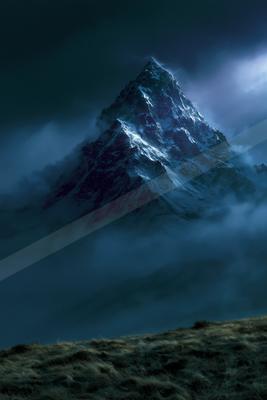 A sharp, snow-covered mountain peak rises dramatically through thick, dark clouds under a moody night sky, with a grassy hillside in the foreground.