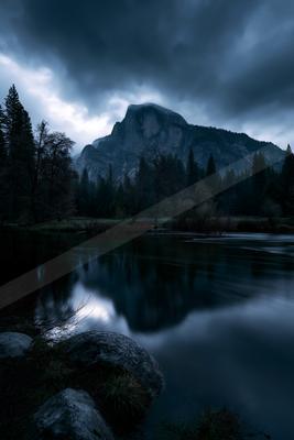 A serene landscape of mountains, lake, valley.