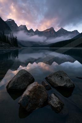A brown-toned moody photograph of lakeside, valley, alp.