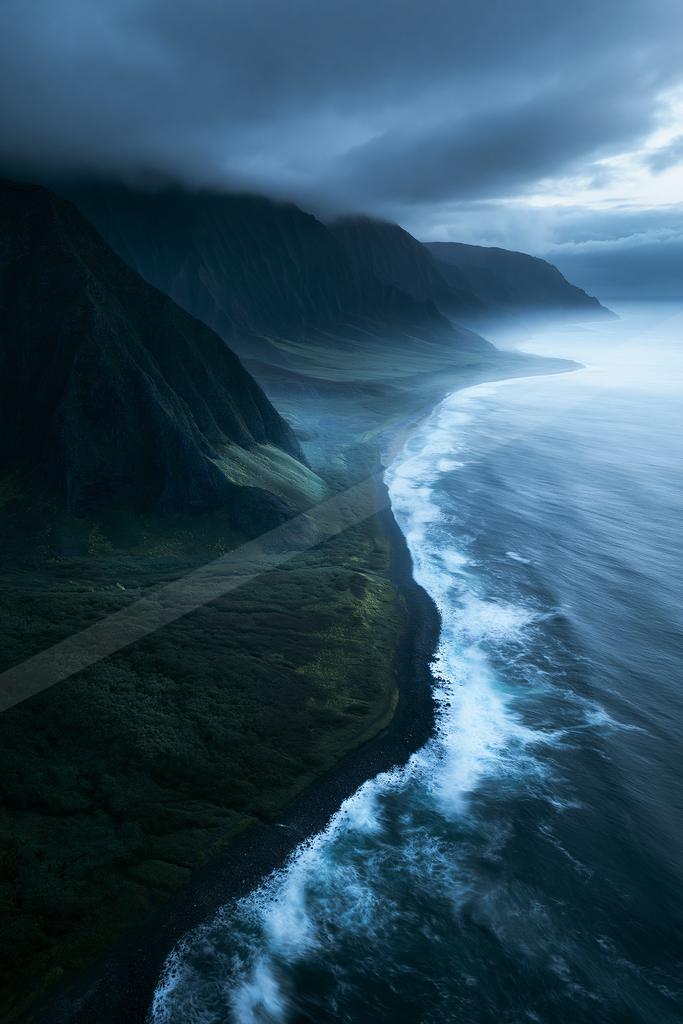 A dramatic long exposure water scene of ocean, storm, valley.